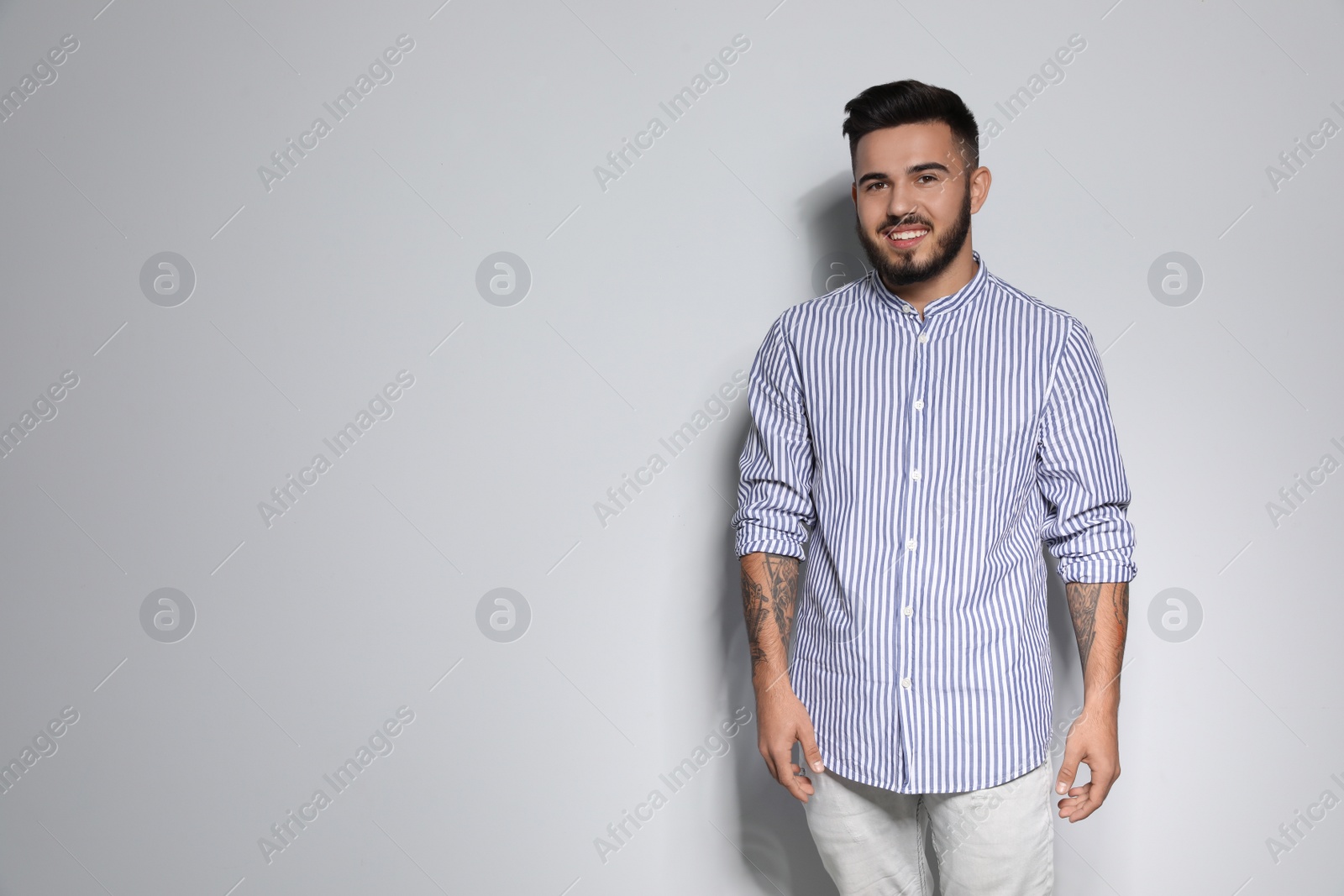 Photo of Portrait of handsome young man against light background. Space for text