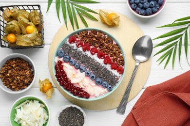 Tasty smoothie bowl with fresh berries and granola served on white wooden table, flat lay