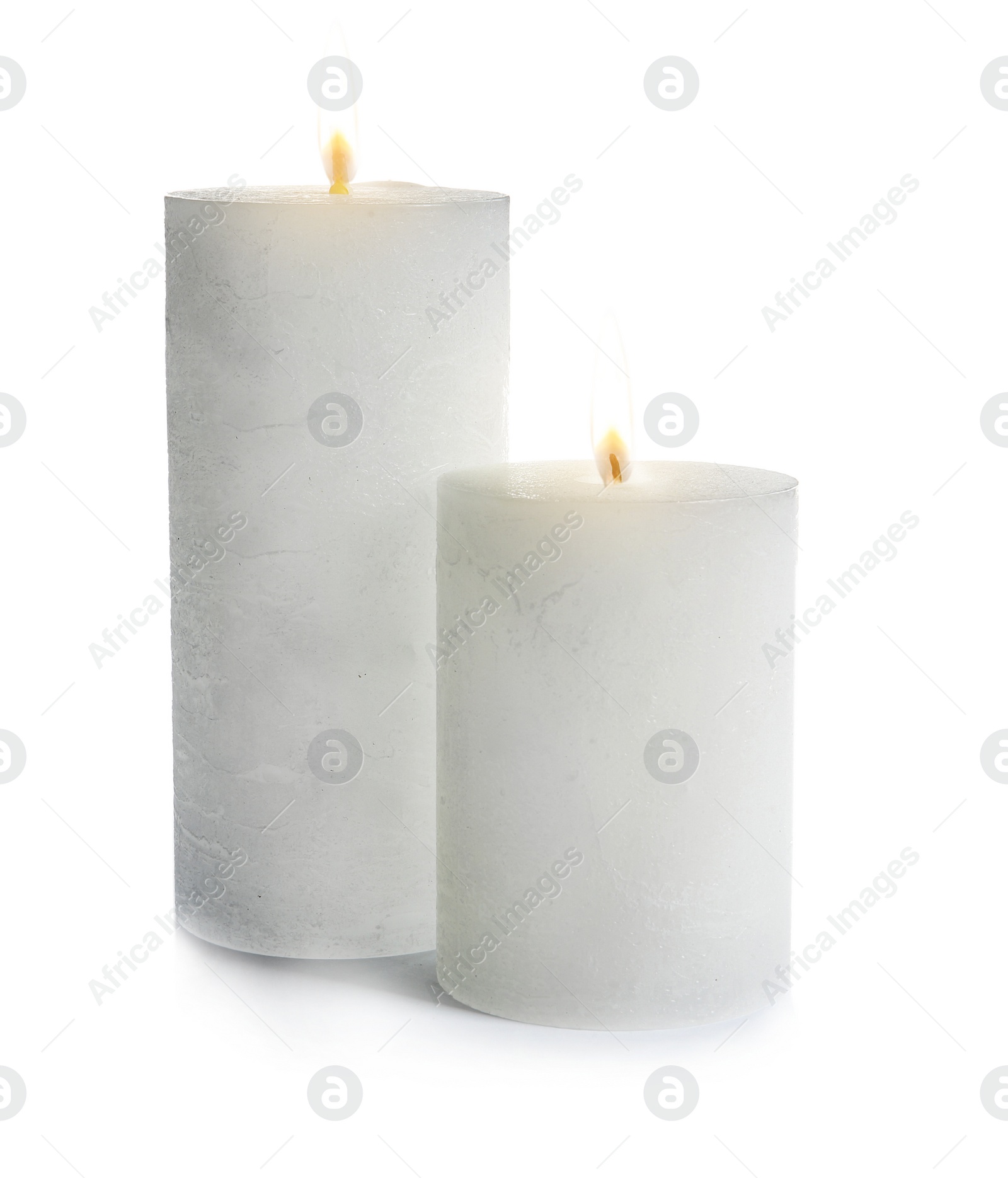 Photo of Two decorative wax candles on white background