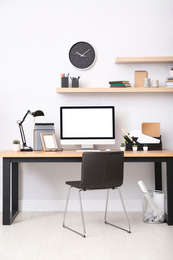 Photo of Modern computer on table in office interior. Stylish workplace