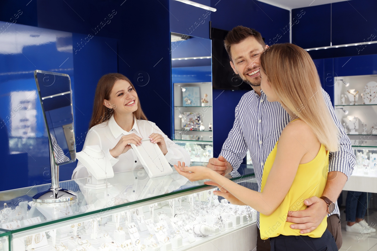 Photo of Couple choosing expensive necklace in jewelry store