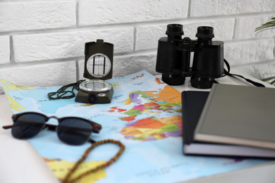 Photo of Composition with world map and different items on table. Trip planning