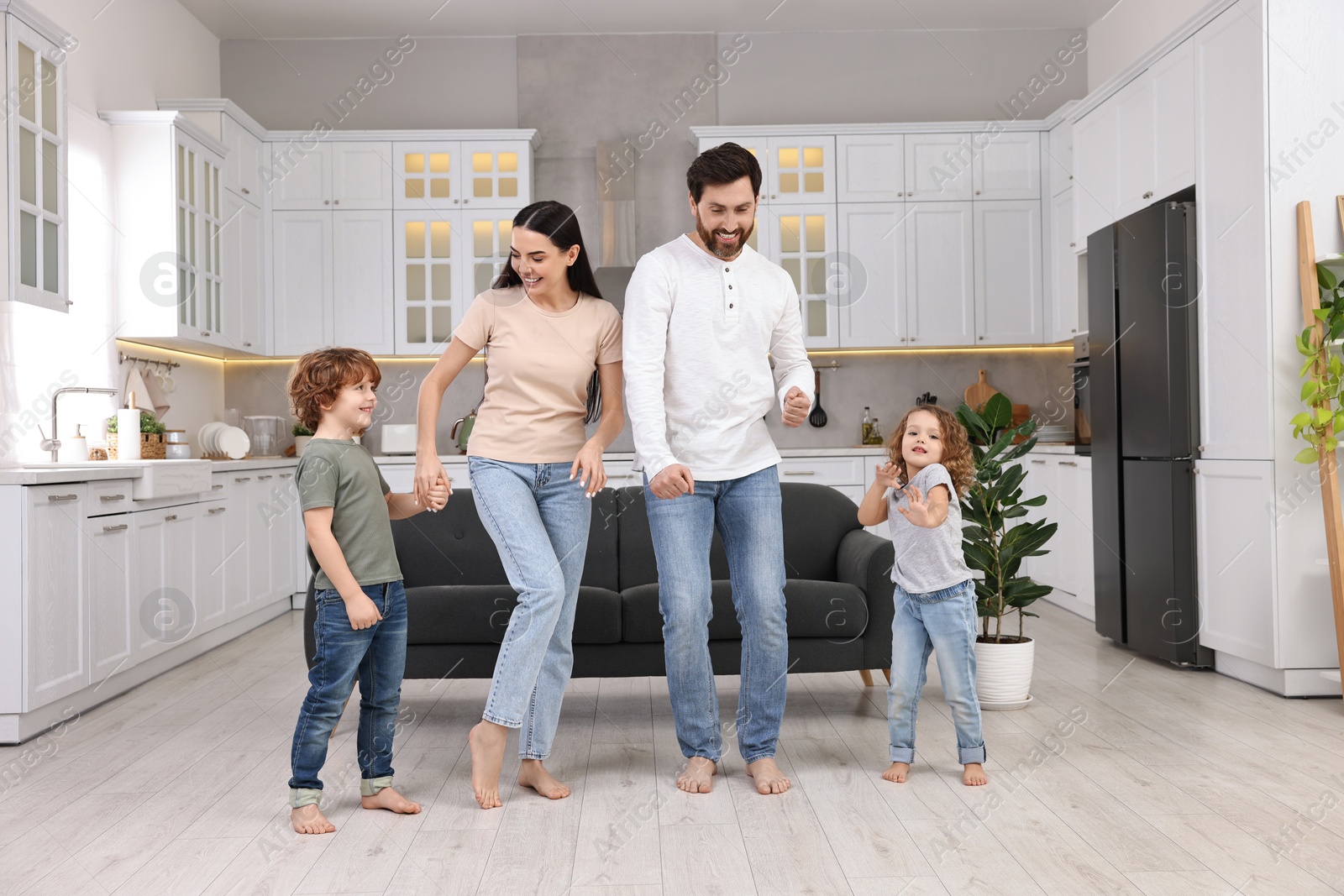 Photo of Happy family dancing and having fun at home