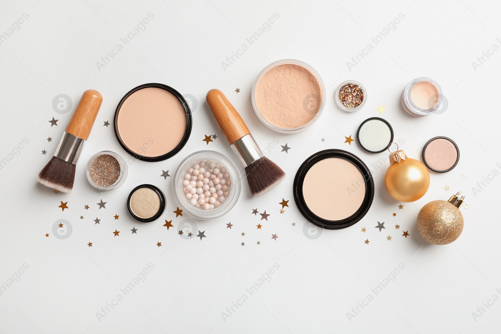 Photo of Flat lay composition with makeup products and Christmas decor on white background