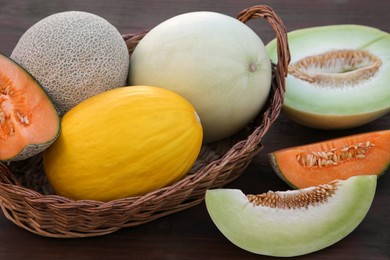 Photo of Many tasty ripe melons on wooden table
