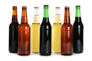 Photo of Bottles with different beer on white background