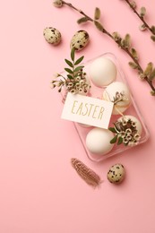 Flat lay composition with eggs, natural decor and word Easter on pink background. Space for text