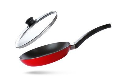 Image of New frying pan and glass lid on white background