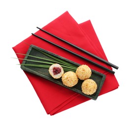 Photo of Delicious sesame balls, green leaves and chopsticks on white background, top view