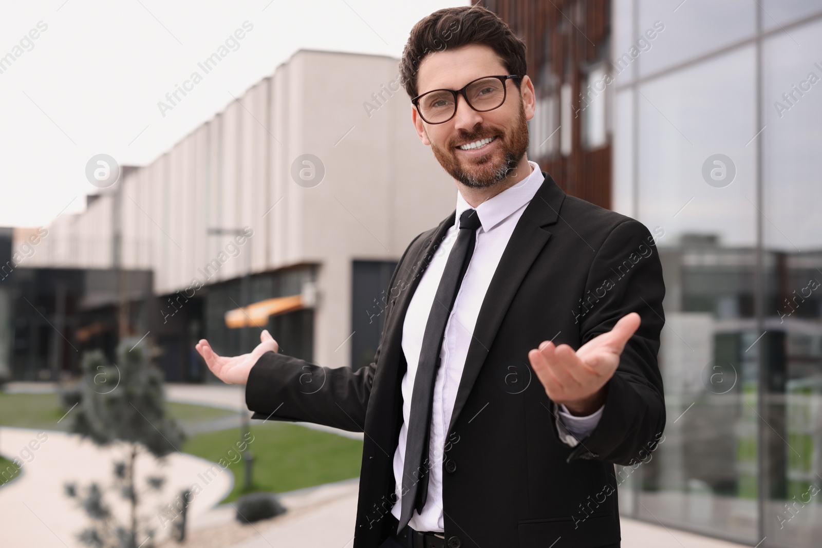 Photo of Handsome real estate agent outdoors. Space for text