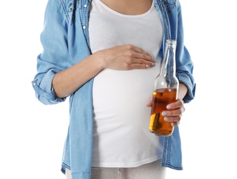 Photo of Future mother with bottle of alcohol drink on white background, closeup. Bad habits during pregnancy