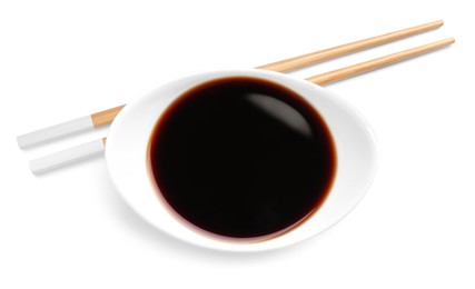 Bowl of soy sauce with chopsticks on white background, top view
