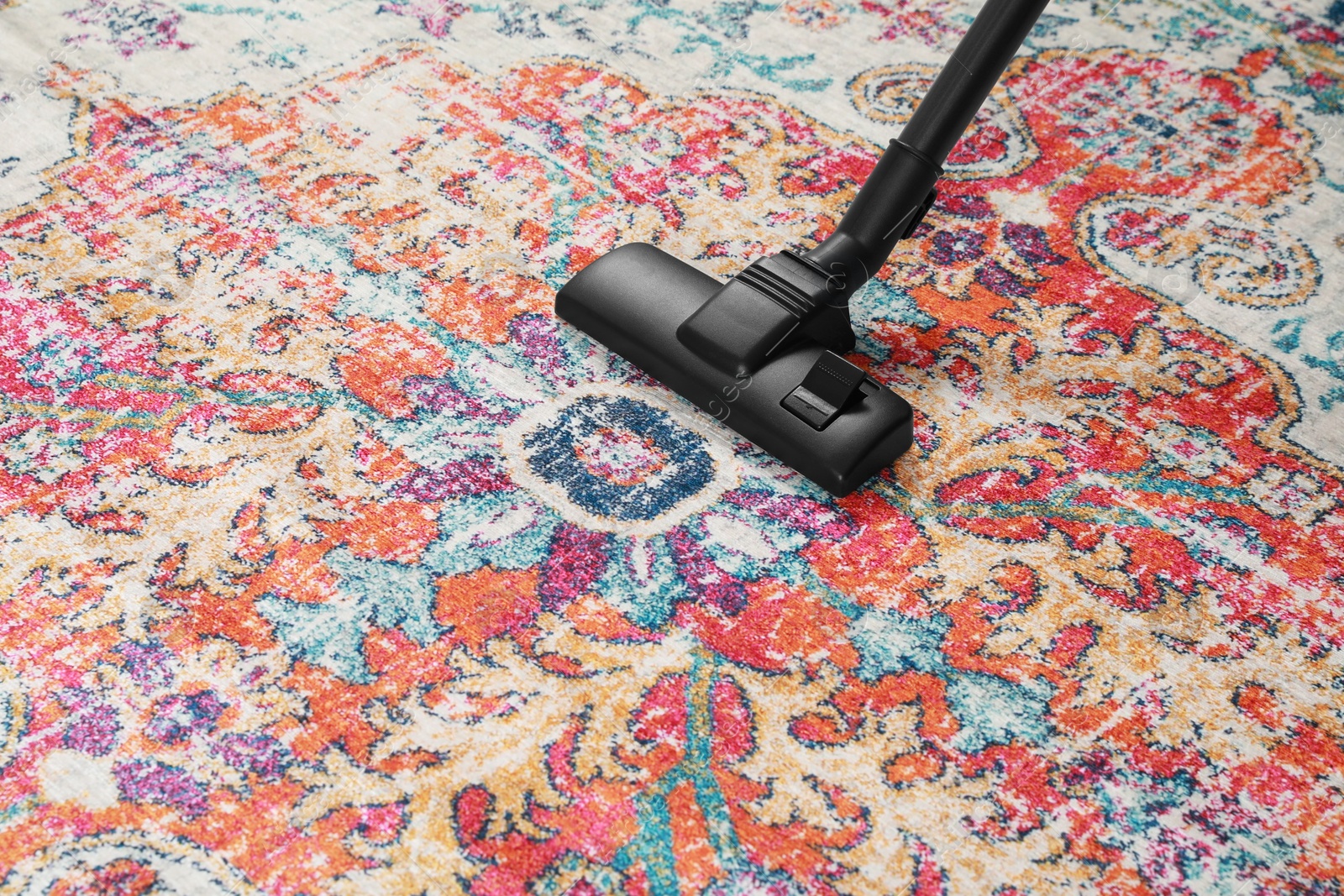 Photo of Removing dirt from carpet with modern vacuum cleaner. Space for text