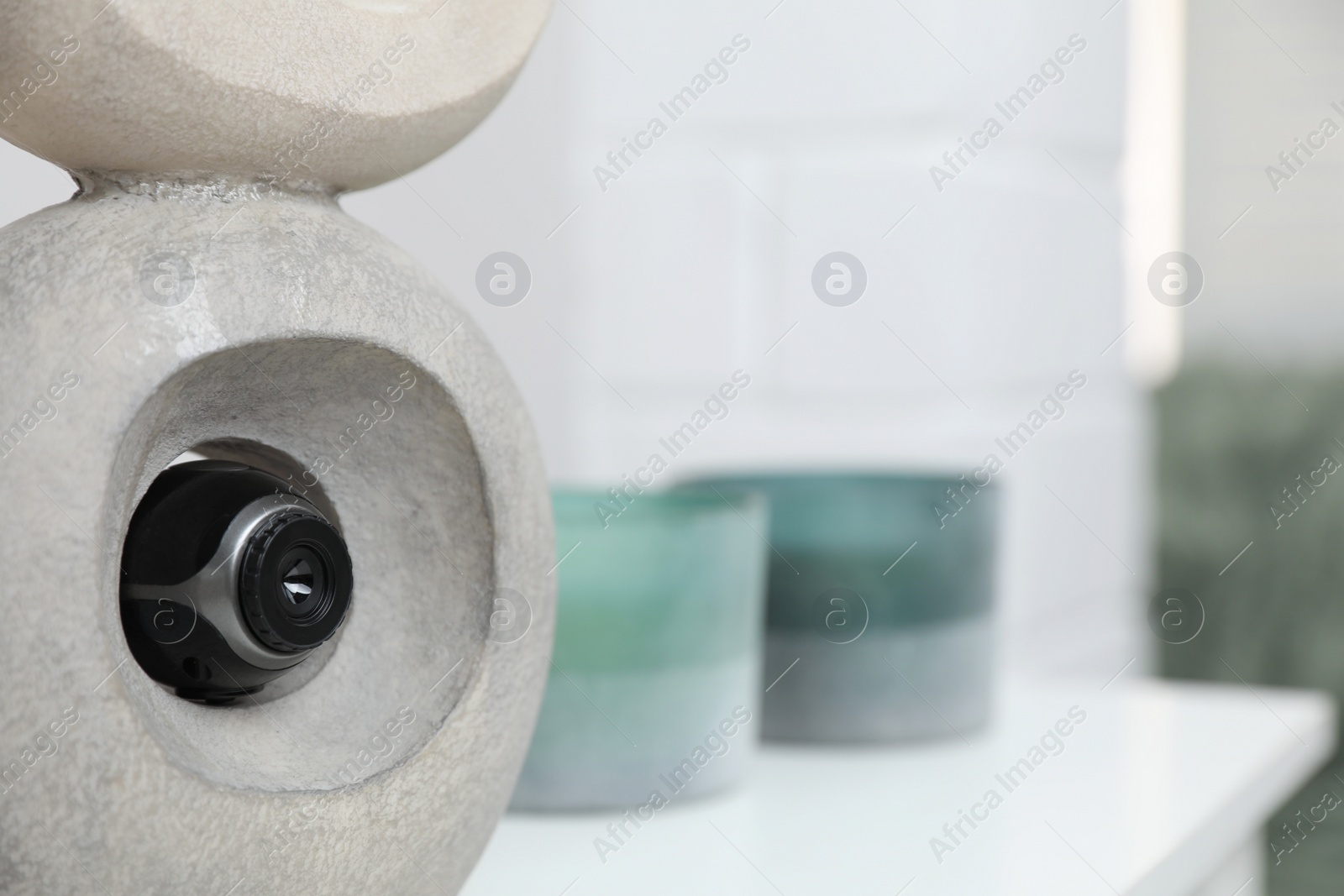 Photo of Small camera hidden in statue at home, closeup