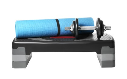 Photo of Step platform, mat and dumbbell on white background. Sports equipment