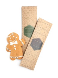 Photo of Scented sachets and gingerbread man on white background, top view