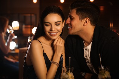 Photo of Man and woman flirting with each other in bar