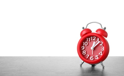 Photo of Alarm clock on table against white background. Time concept