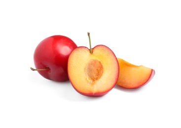 Photo of Cut and whole cherry plums on white background