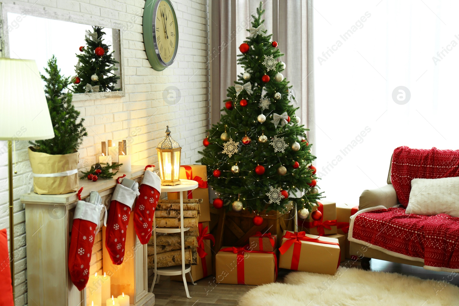 Photo of Stylish interior with beautiful Christmas tree and decorative fireplace