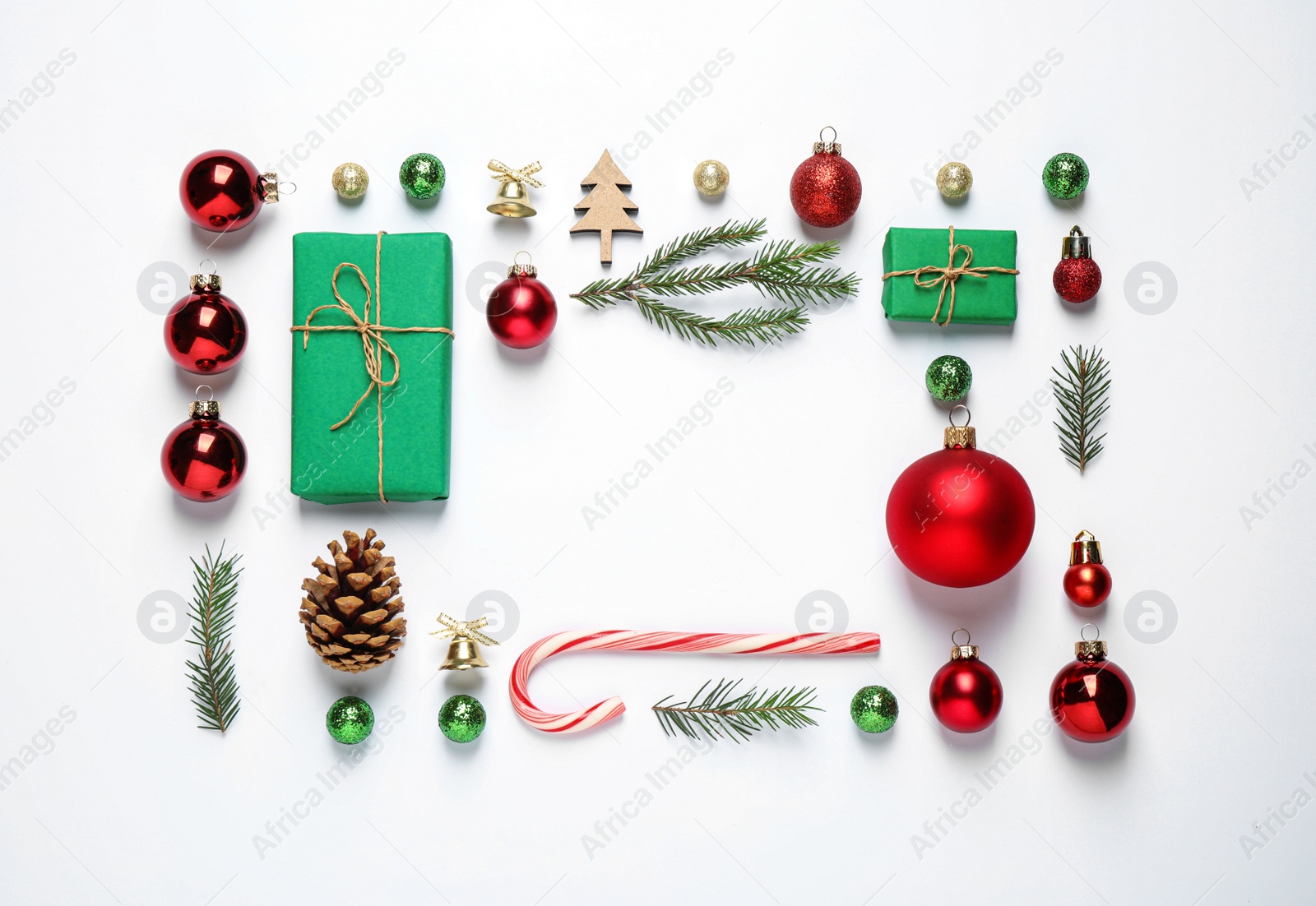 Photo of Frame of Christmas tree branches and festive decoration on white background, top view. Space for text