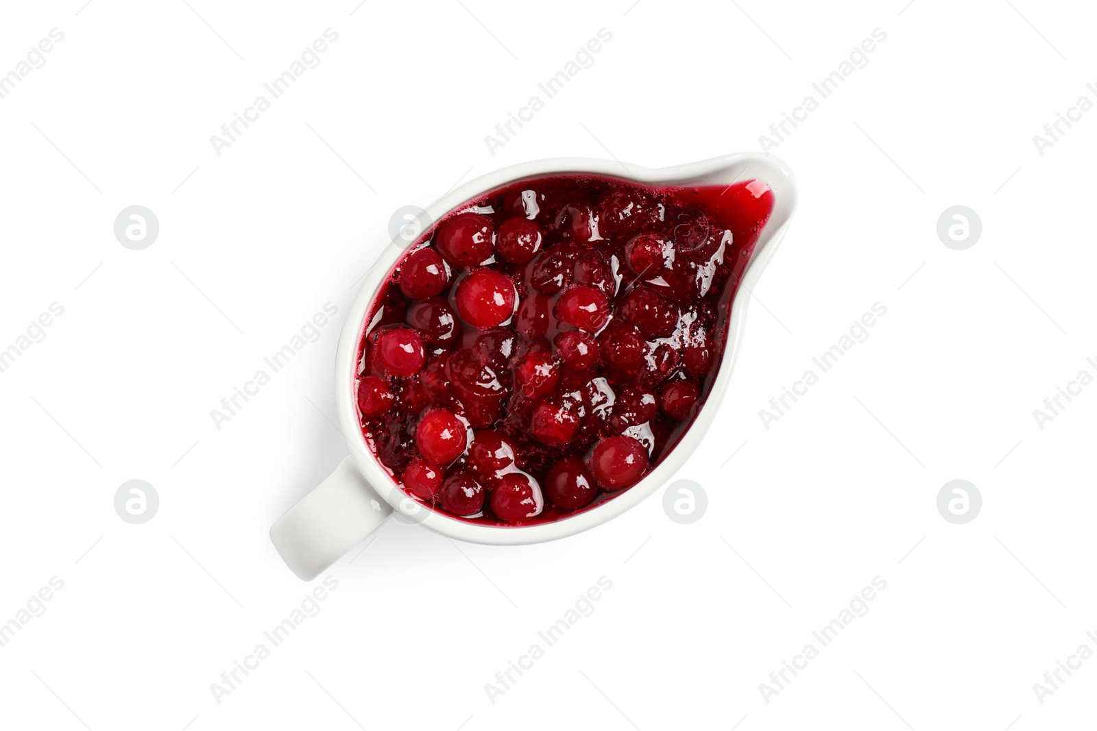 Photo of Cranberry sauce in pitcher isolated on white, top view