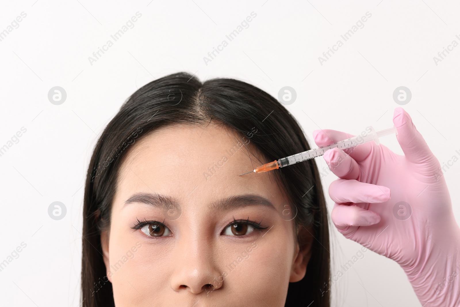 Photo of Woman getting facial injection on white background, closeup