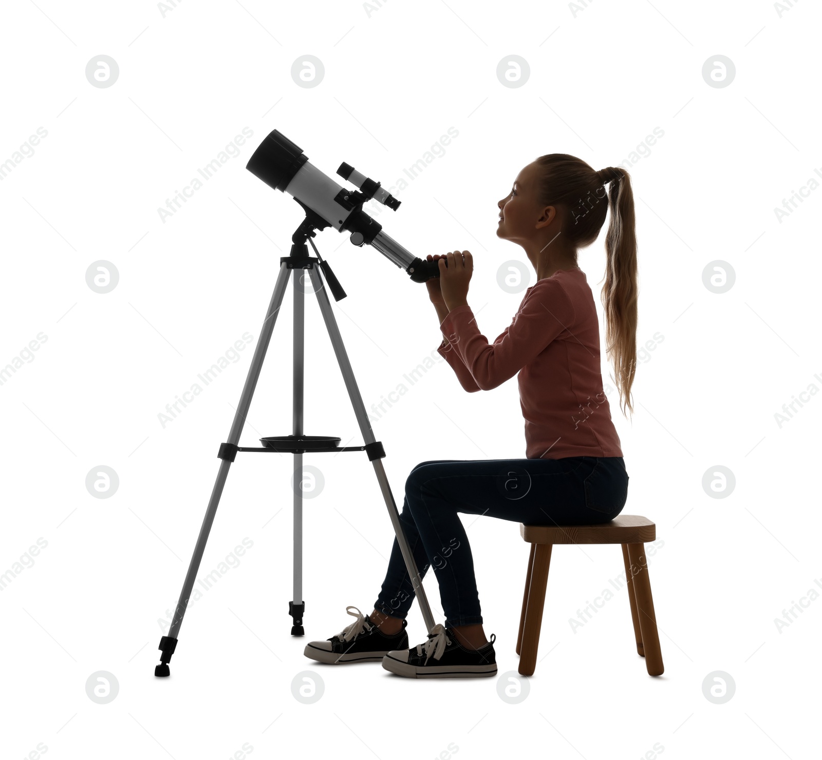 Photo of Happy little girl with telescope on white background