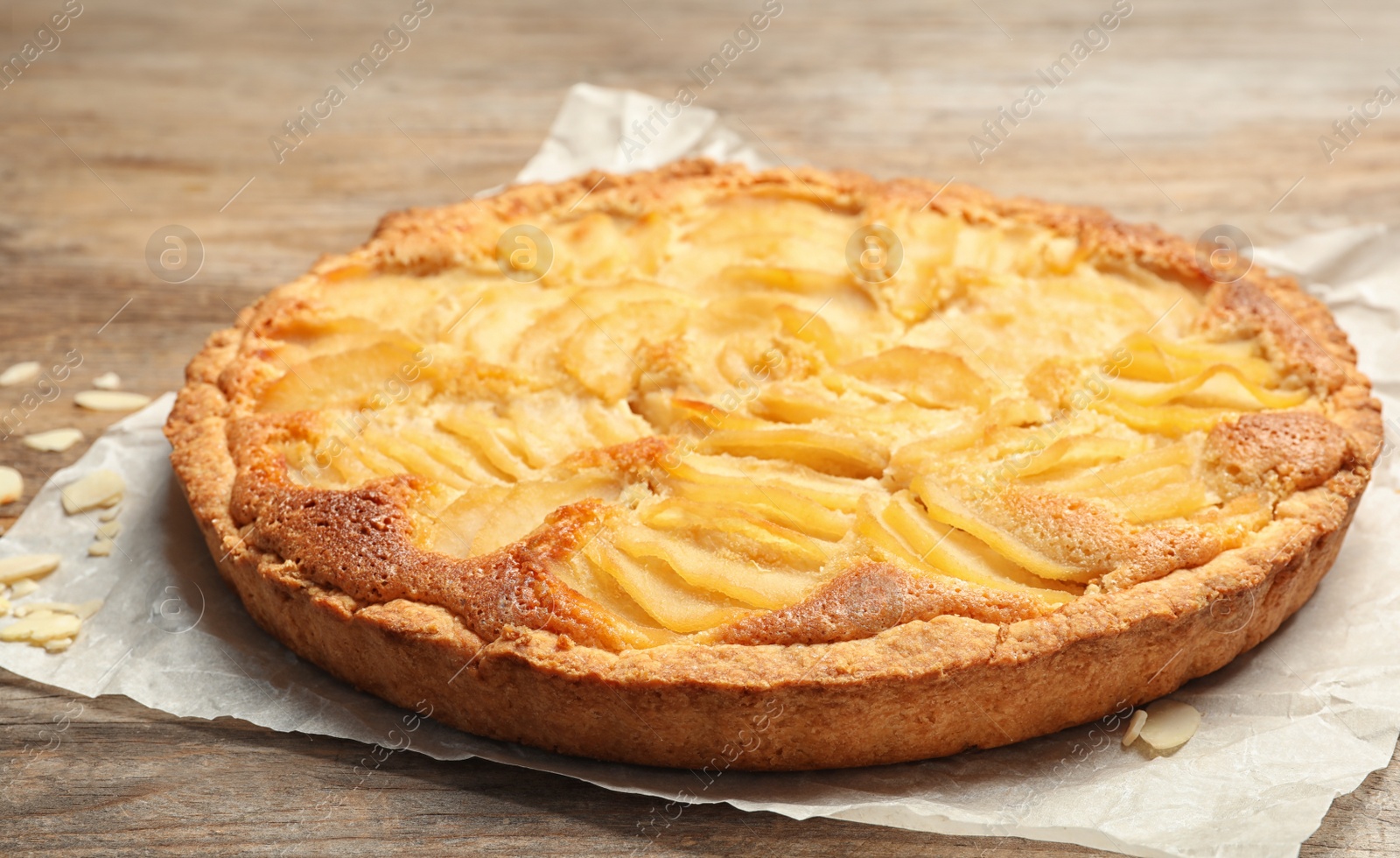 Photo of Delicious sweet pear tart on wooden table