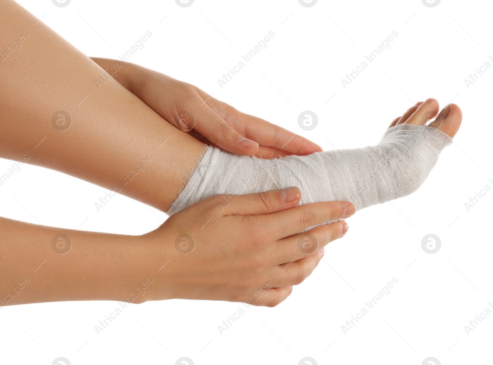 Photo of Woman wrapping foot in medical bandage on white background, closeup