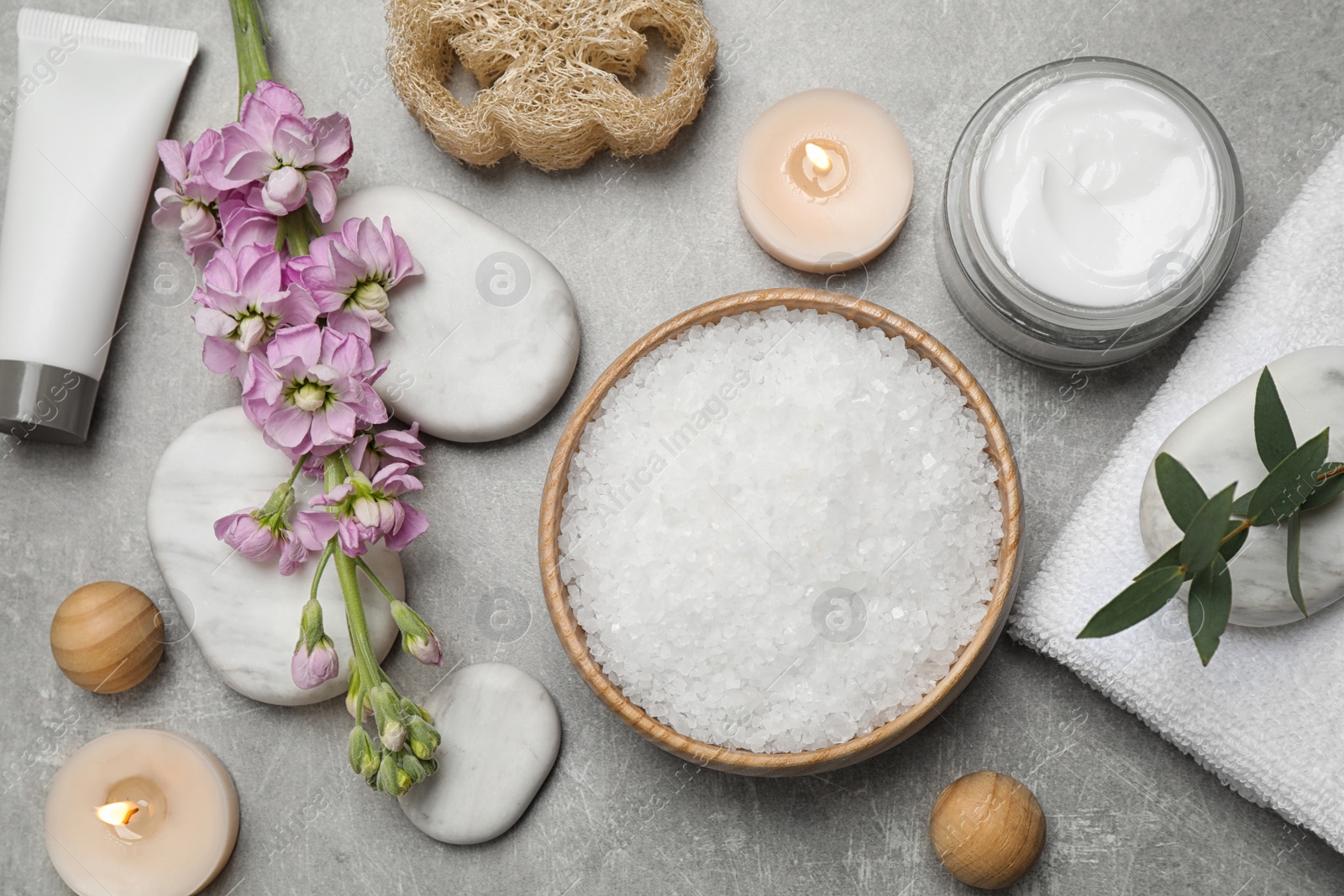 Photo of Flat lay composition with cosmetics and sea salt on grey marble table. Spa treatment