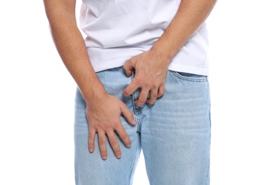 Man scratching crotch on white background, closeup. Annoying itch