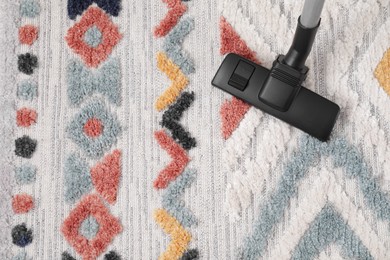 Photo of Hoovering carpet with modern vacuum cleaner indoors, top view. Space for text