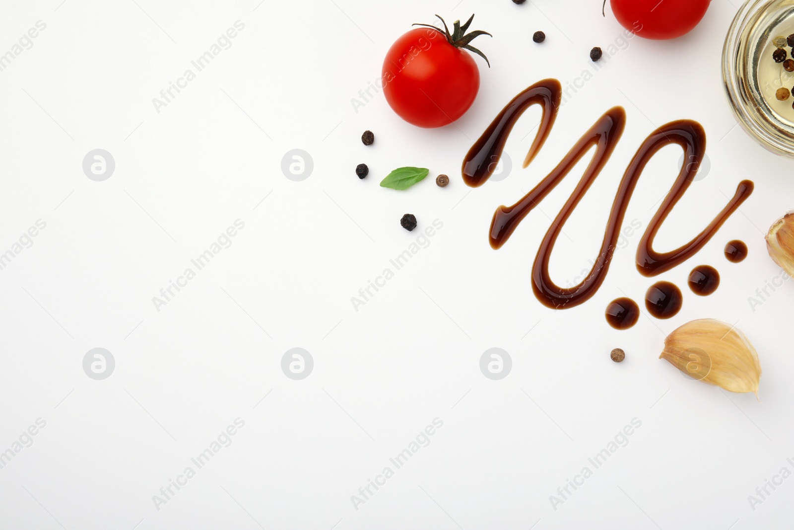 Photo of Organic balsamic vinegar and cooking ingredients on white background, flat lay. Space for text