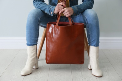 Woman in stylish leather shoes with bag indoors, closeup