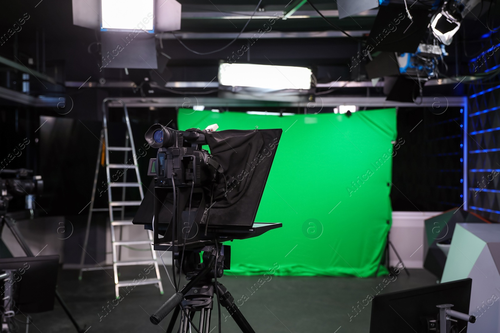 Photo of Modern video recording studio with professional equipment, focus on camera