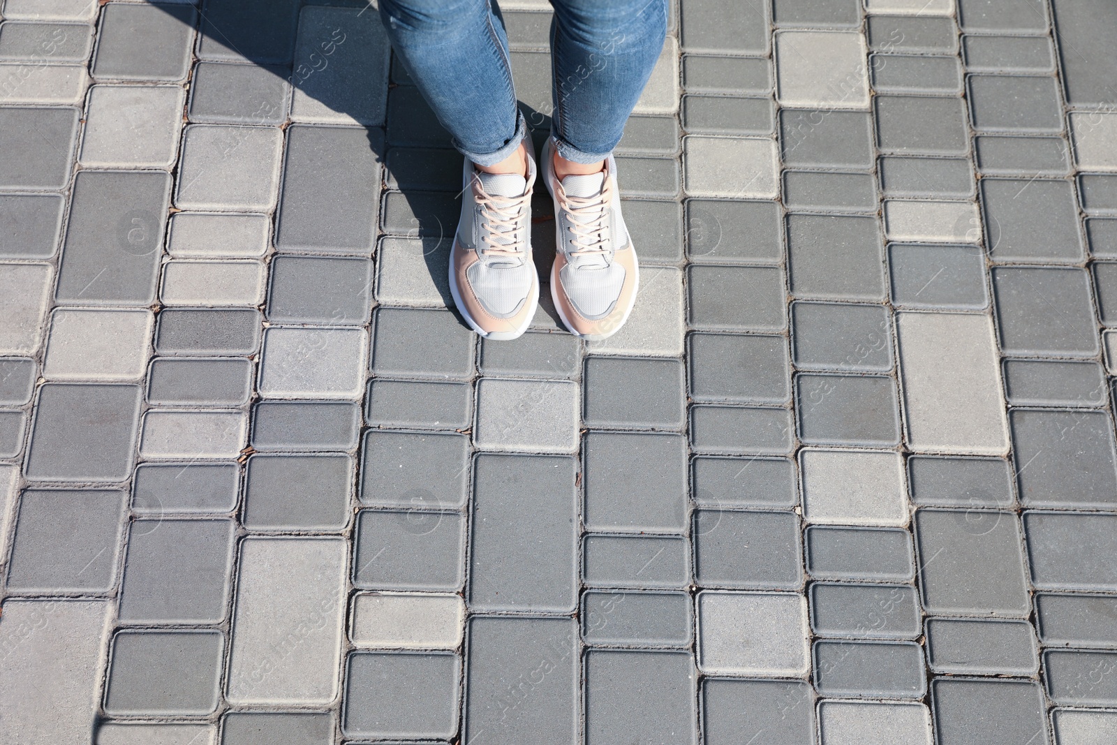 Photo of Woman standing outdoors, top view with space for text. Choosing way concept.