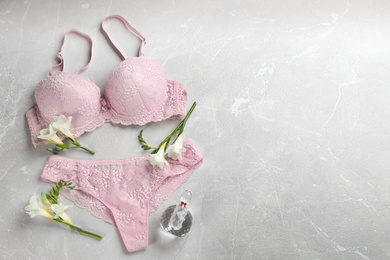 Photo of Flat lay composition with women's underwear on light grey background, space for text