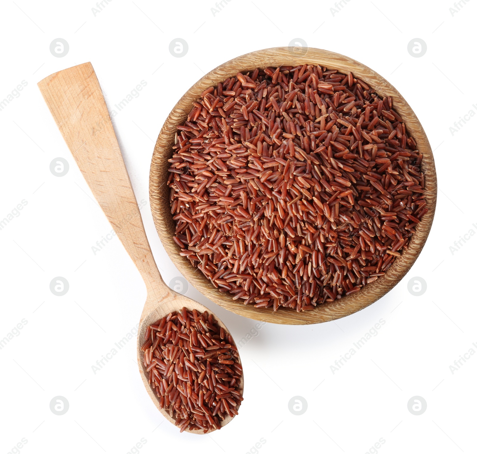 Photo of Bowl and spoon with uncooked brown rice on white background, top view