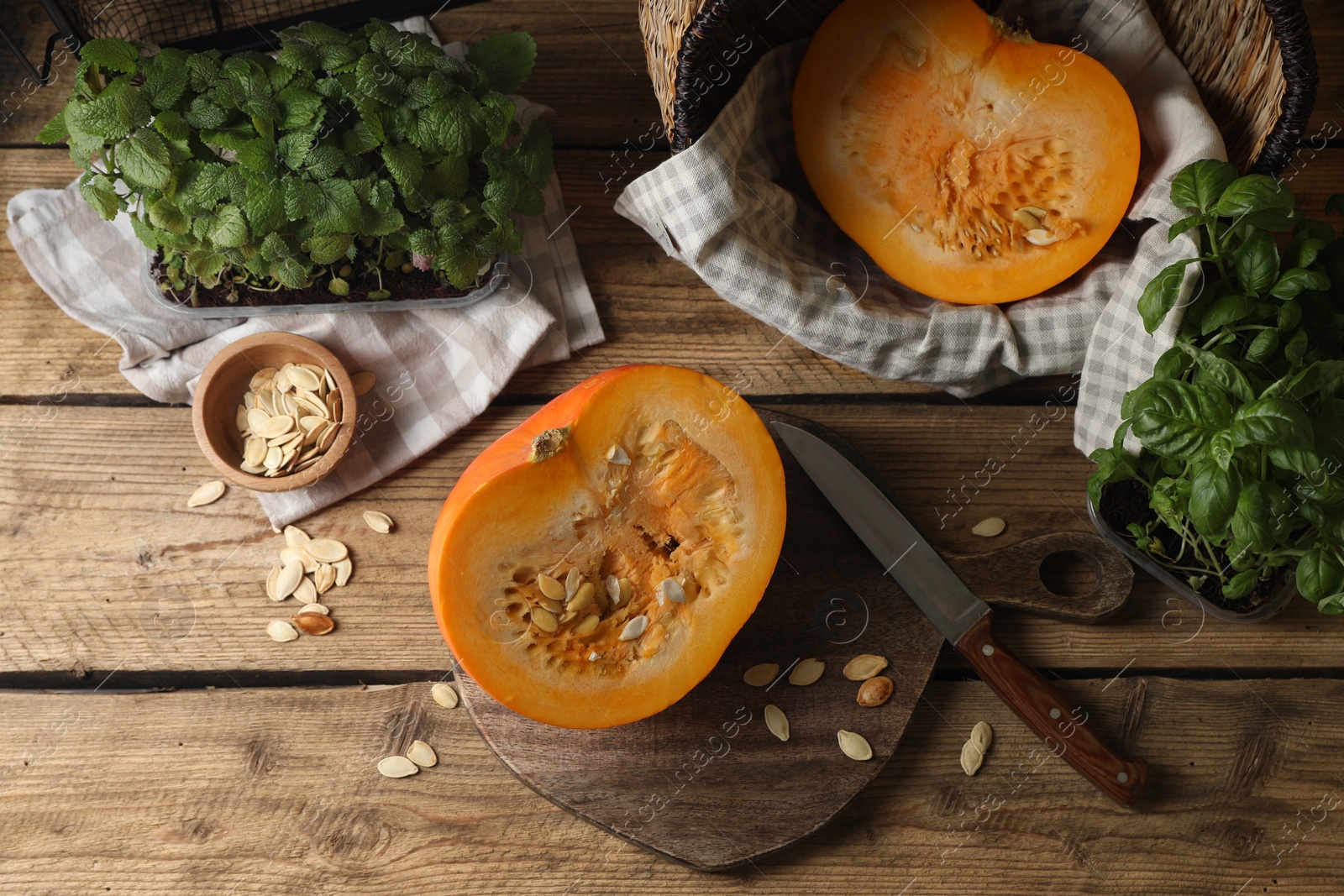 Photo of Cut fresh ripe pumpkin on wooden table, flat lay