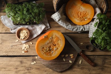 Cut fresh ripe pumpkin on wooden table, flat lay