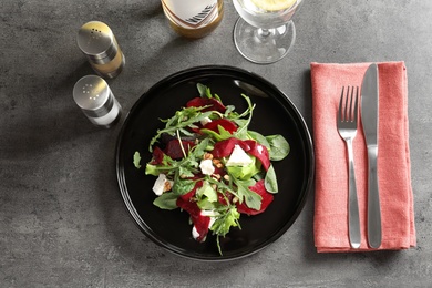 Plate with delicious beet salad served on table, top view