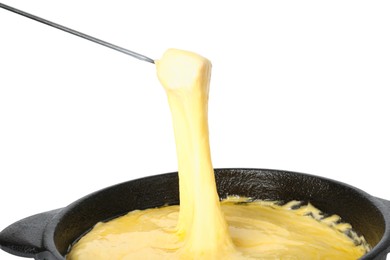 Dipping piece of ham into fondue pot with tasty melted cheese isolated on white