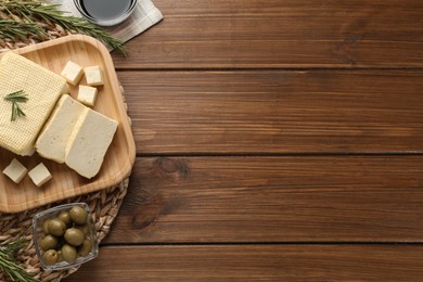 Photo of Flat lay with cut tofu on wooden table, space for text. Soya bean curd