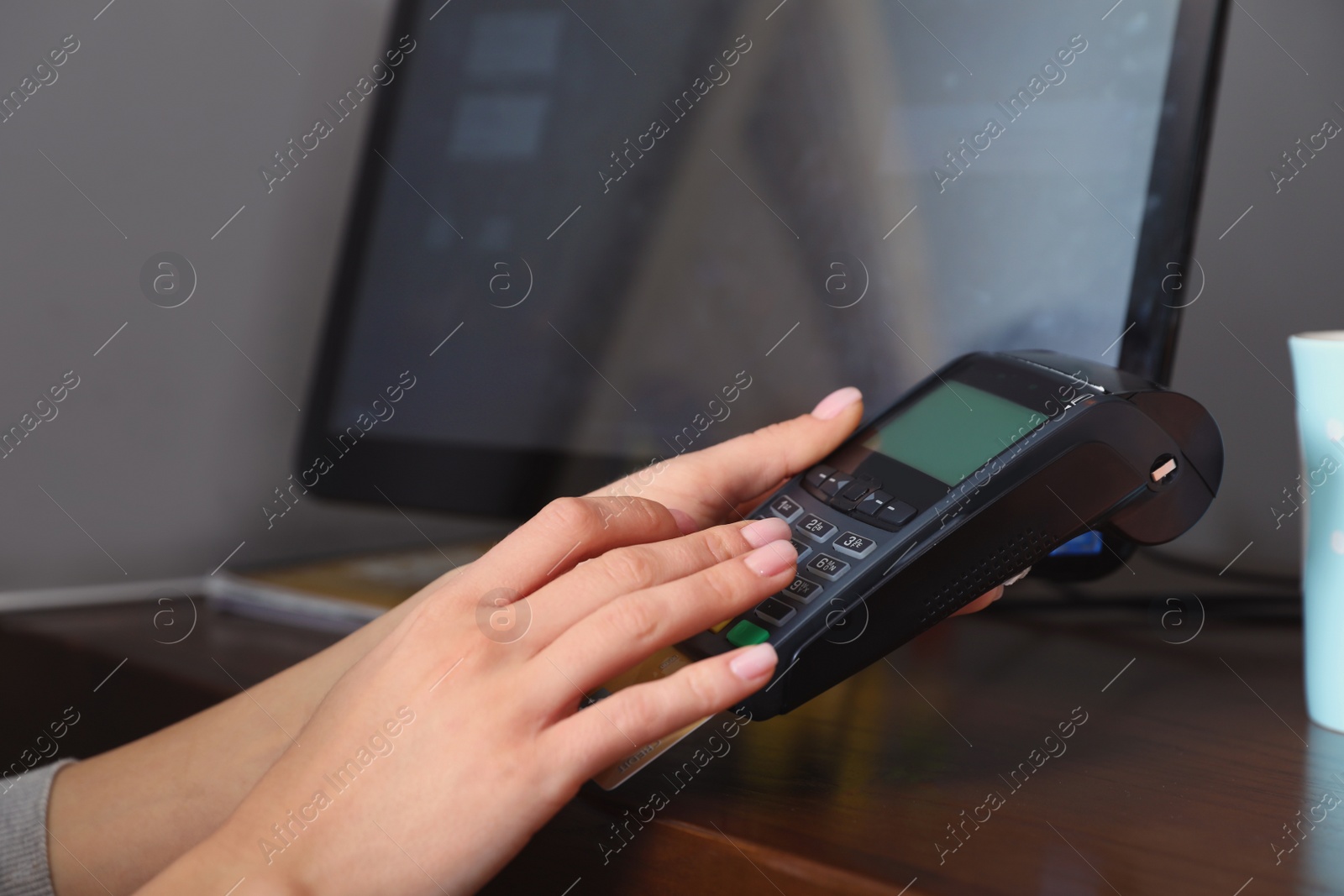 Photo of Woman using credit card machine for non cash payment in cafe, closeup. Space for text