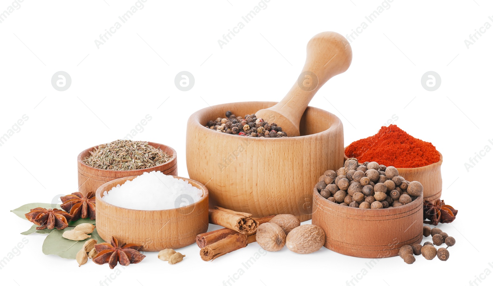 Photo of Mortar with pestle and different spices on white background