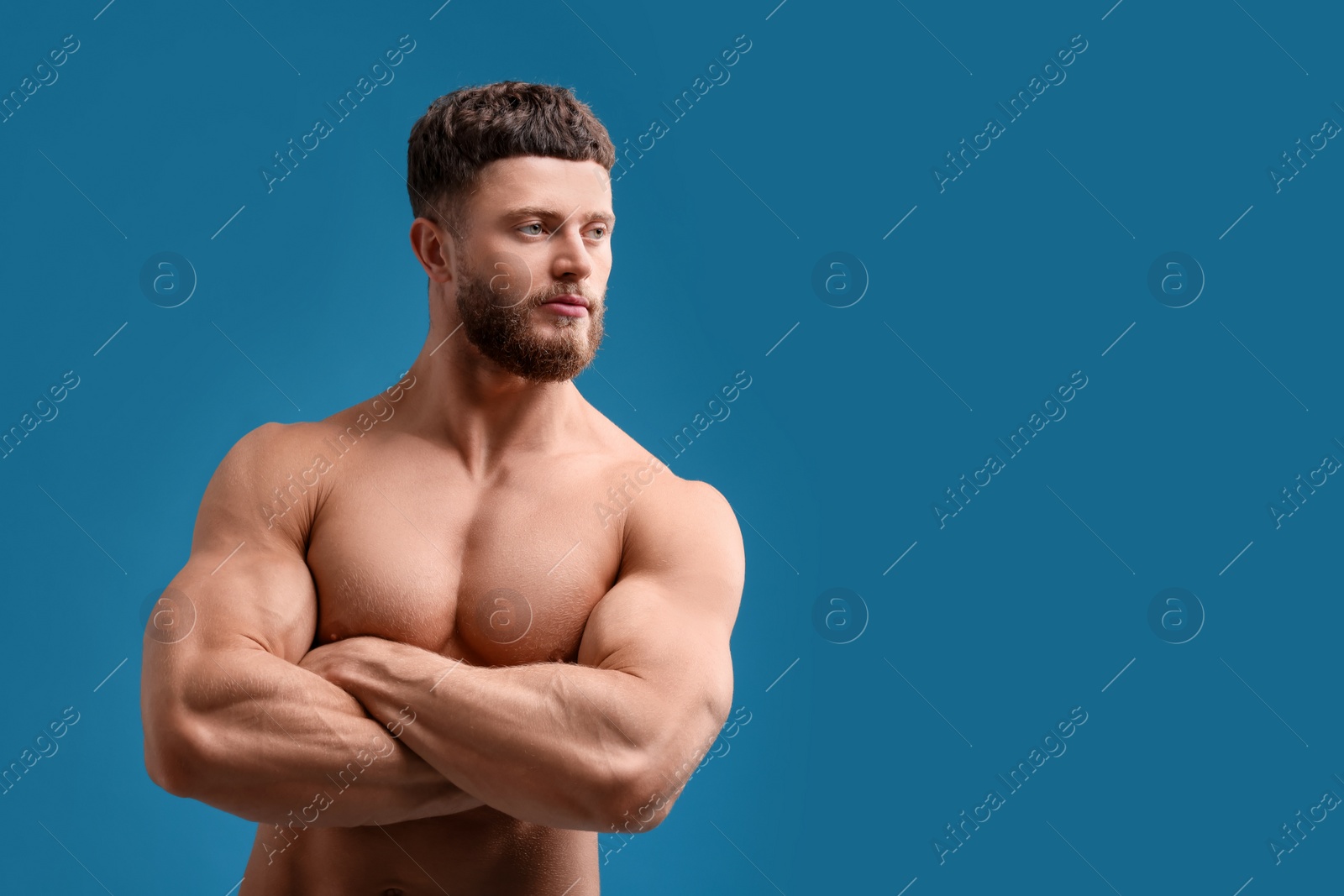 Photo of Handsome muscular man on light blue background, space for text. Sexy body