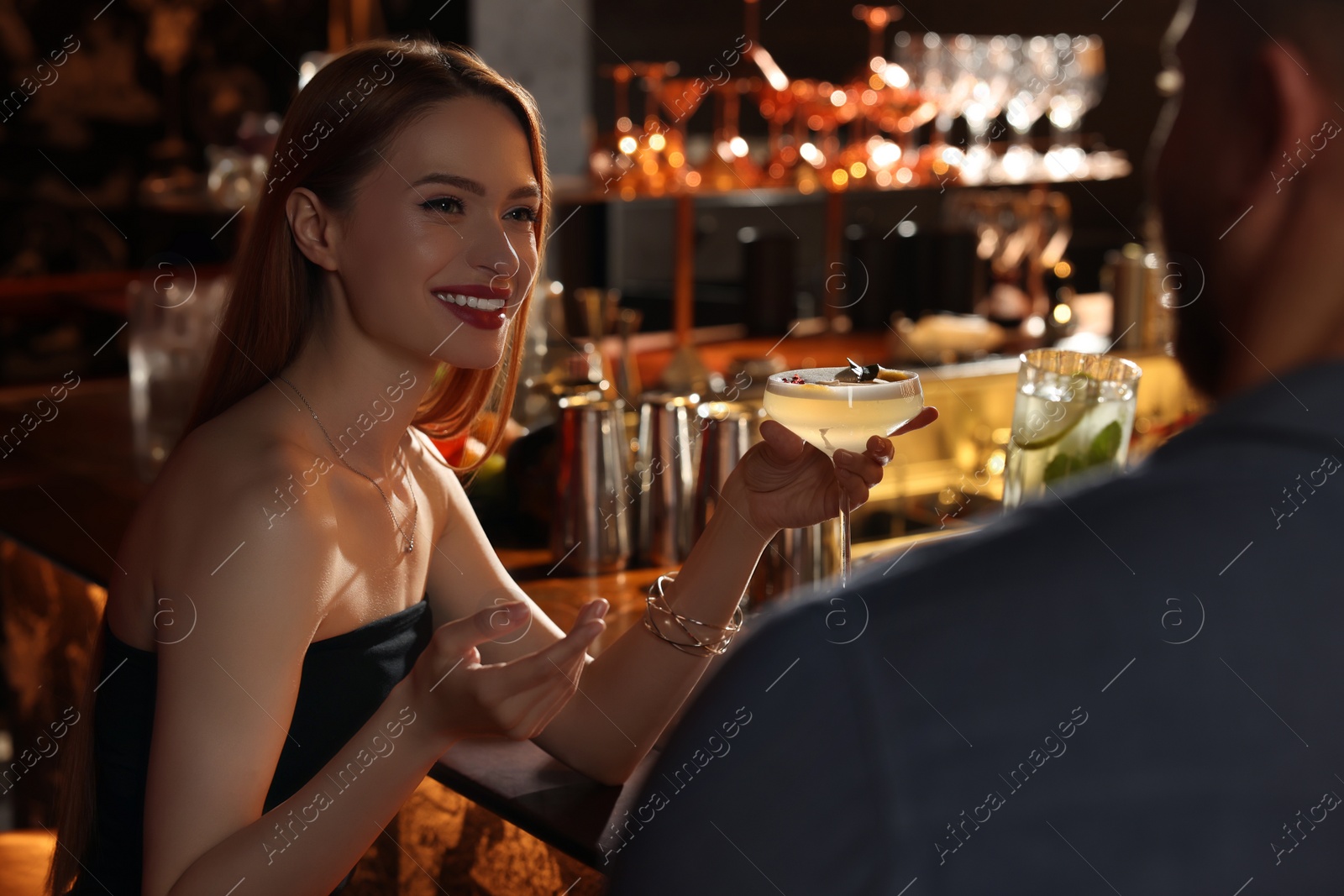 Photo of Couple with fresh cocktails at bar counter