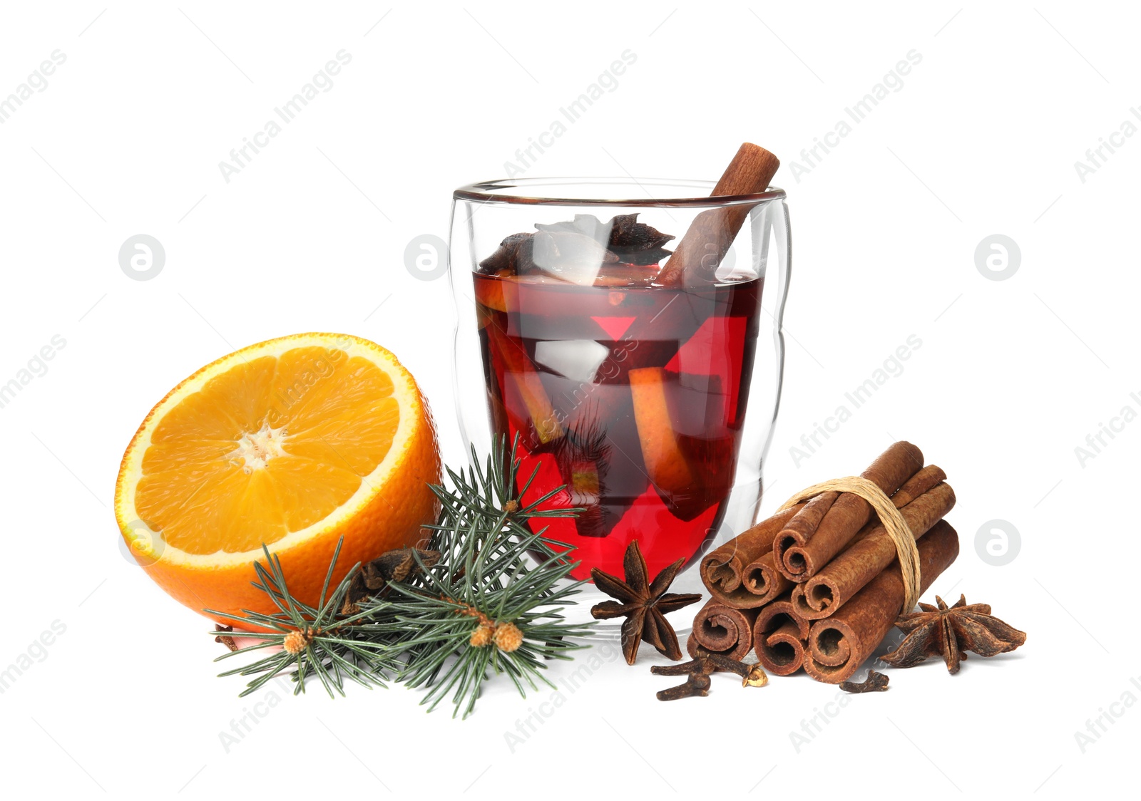 Photo of Glass of mulled wine with fir branch, cinnamon and orange isolated on white