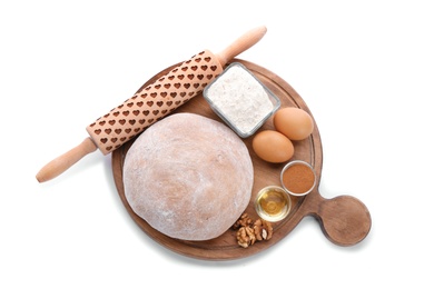 Photo of Wooden board with raw rye dough and ingredients on white background, top view